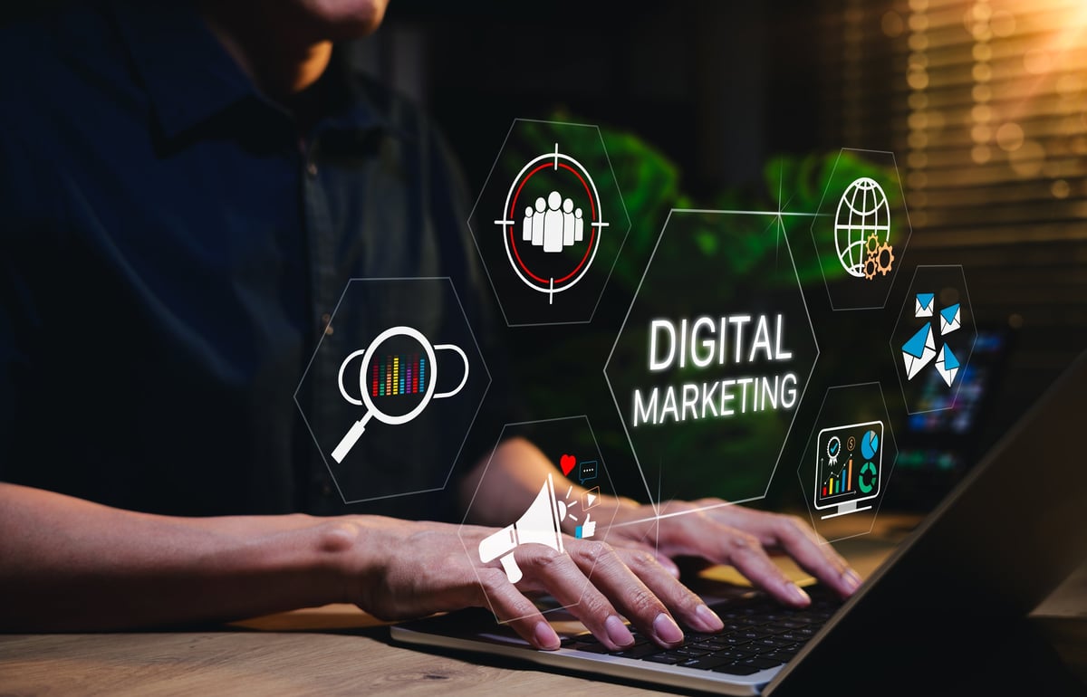 Digital marketing professional working on laptop with analytics dashboard showing growth metrics and online advertising strategies